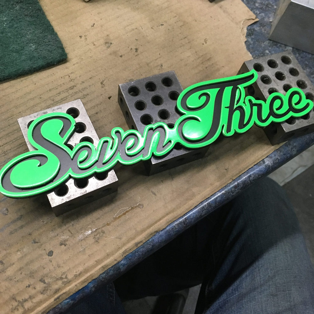 Seven Three Emblem Green on black 2